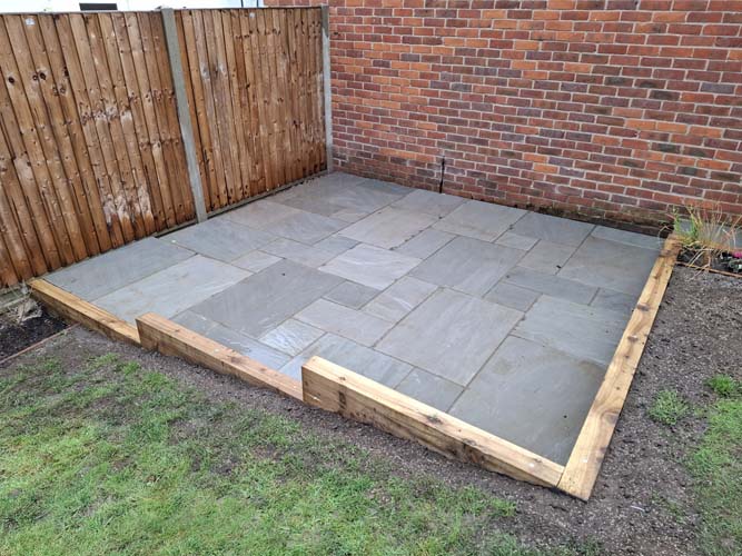 Rejuvenate sloping garden with new patio, terrace, borders and raised bed