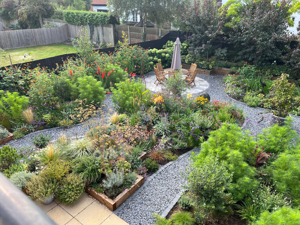 Large Makeover with winding slate paths and herbaceous borders