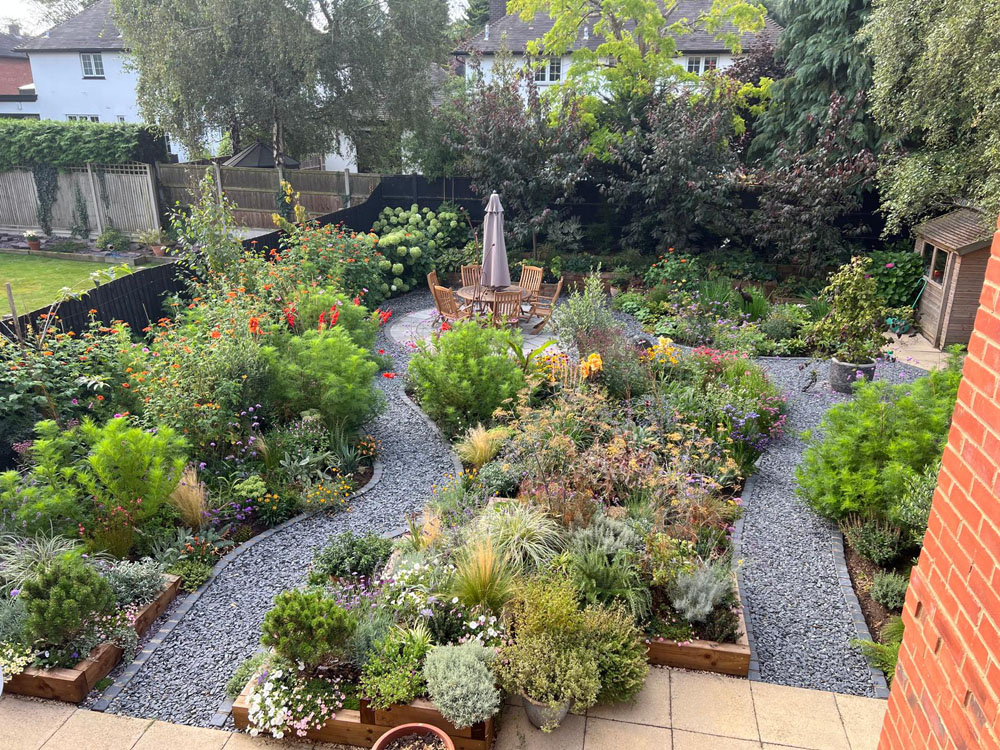 Large Makeover with winding slate paths and herbaceous borders