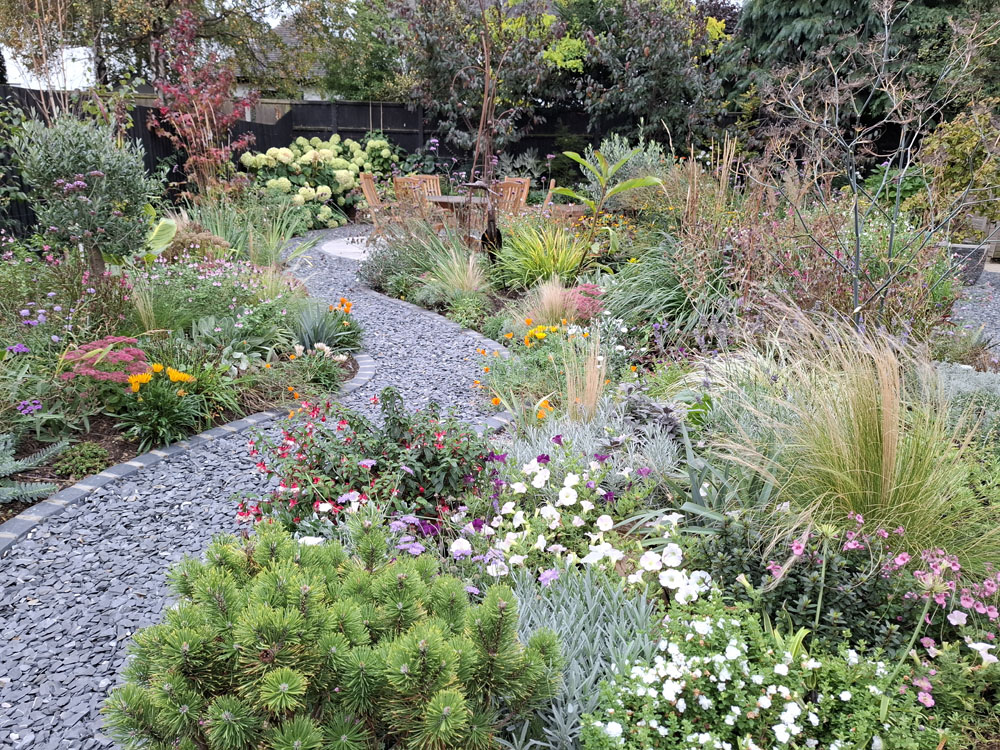 Large Makeover with winding slate paths and herbaceous borders