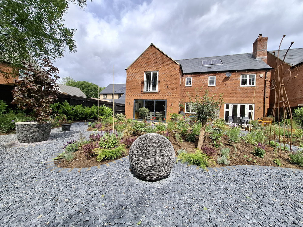 Large Makeover with winding slate paths and herbaceous borders