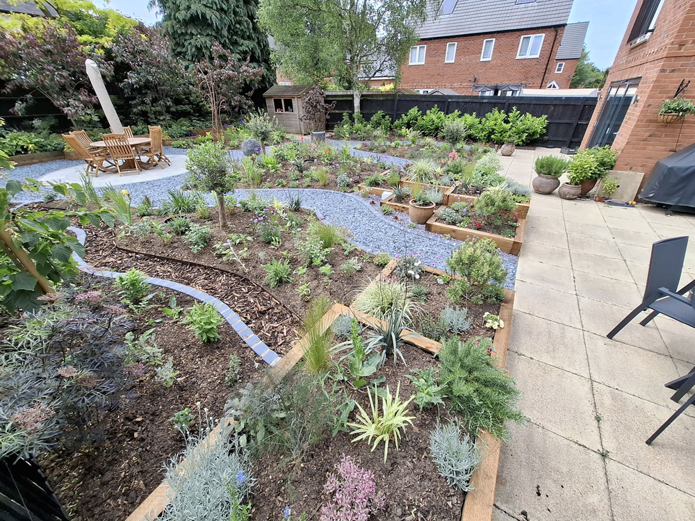 Large Makeover with winding slate paths and herbaceous borders