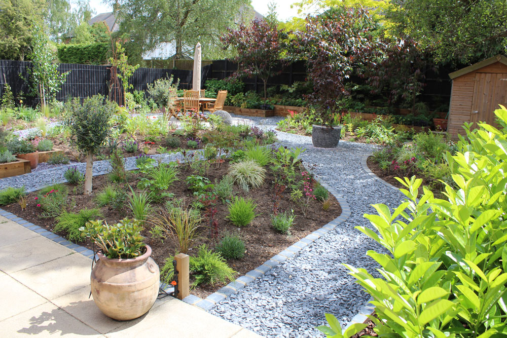Large Makeover with winding slate paths and herbaceous borders