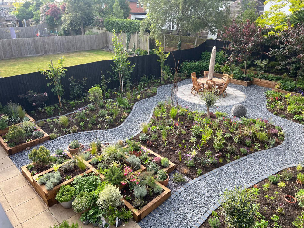 Large Makeover with winding slate paths and herbaceous borders