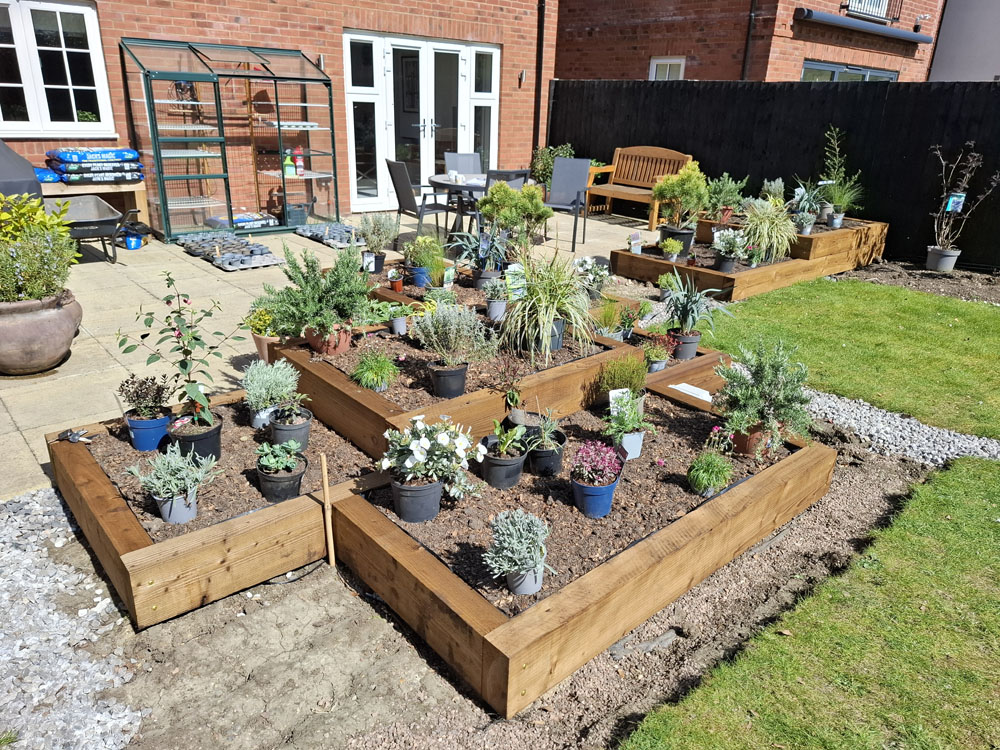 Large Makeover with winding slate paths and herbaceous borders