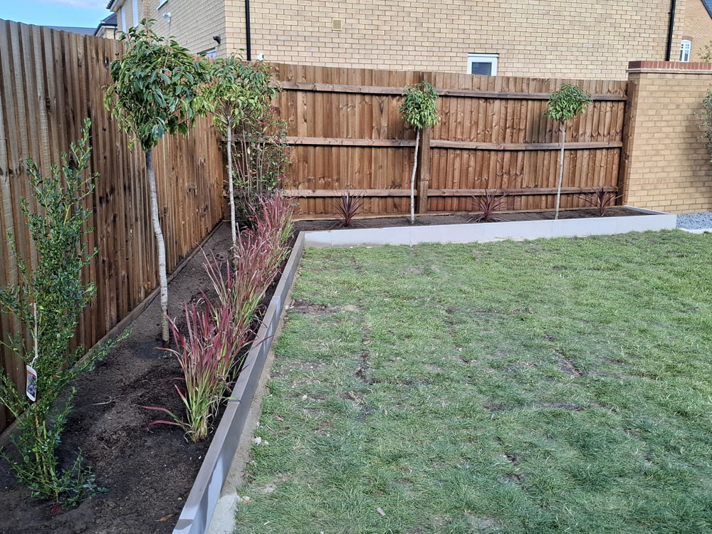 New build, simple concrete raised beds on perimeter