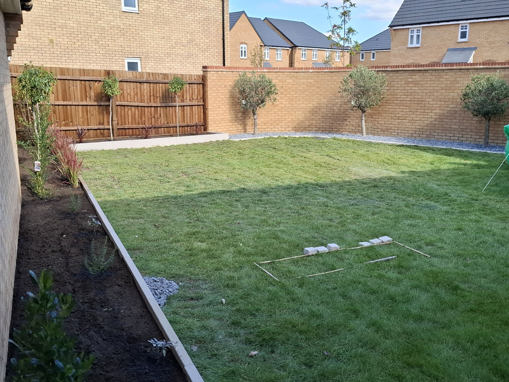New build, simple concrete raised beds on perimeter